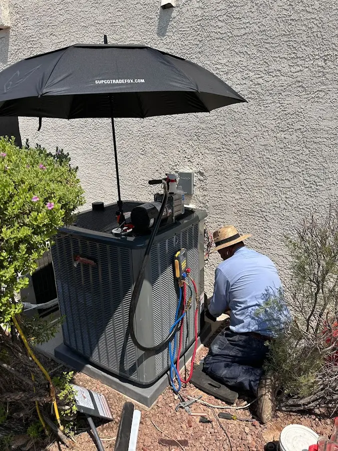 HVAC technician performing outdoor AC maintenance in Baytown